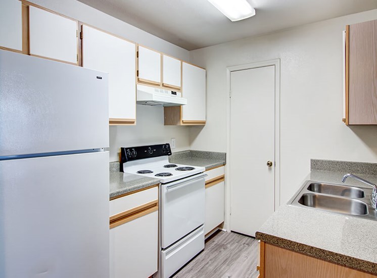 White Cabinetry And Appliances In Kitchen at 8181 Med Center, Houston, 77054